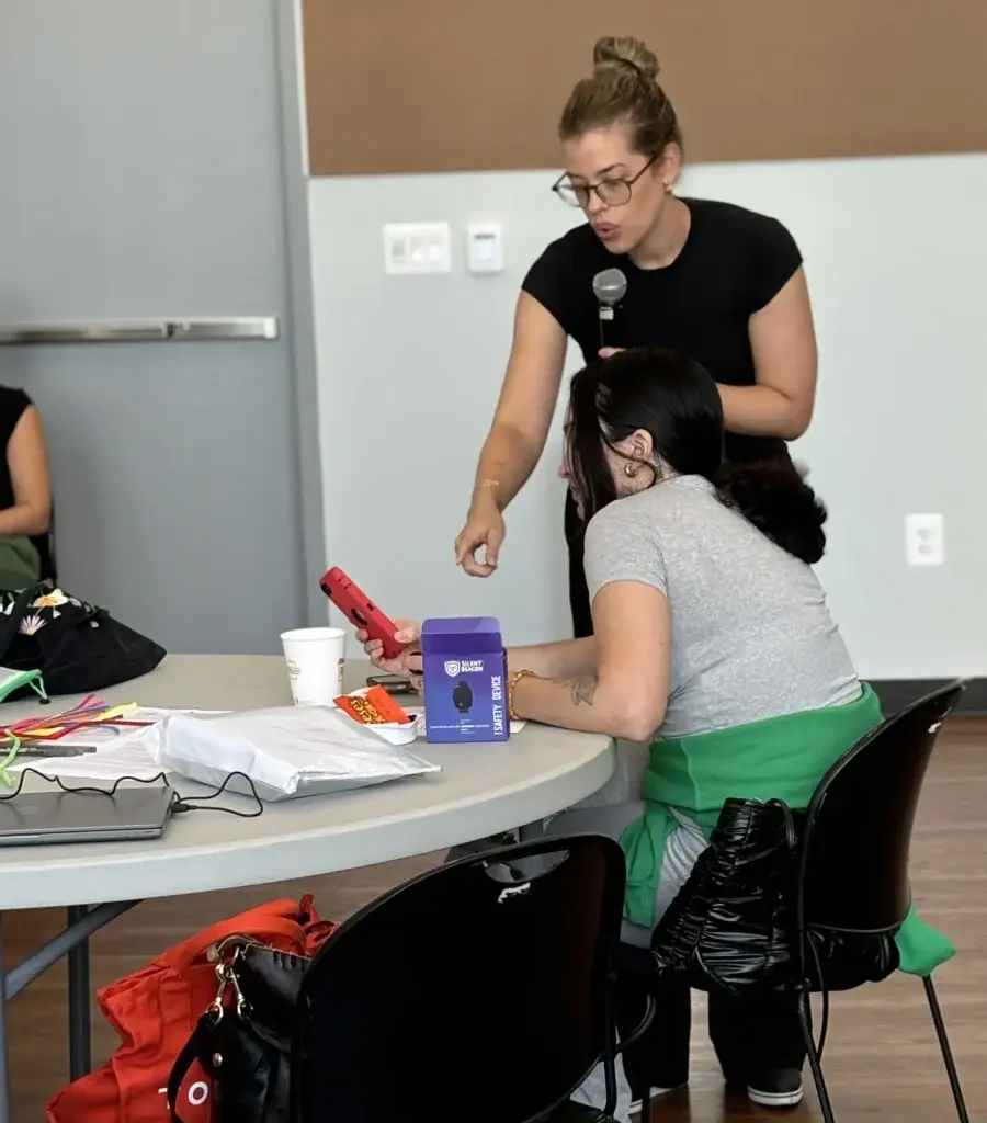 Person going over the Silent Beacon device and its features at an event.