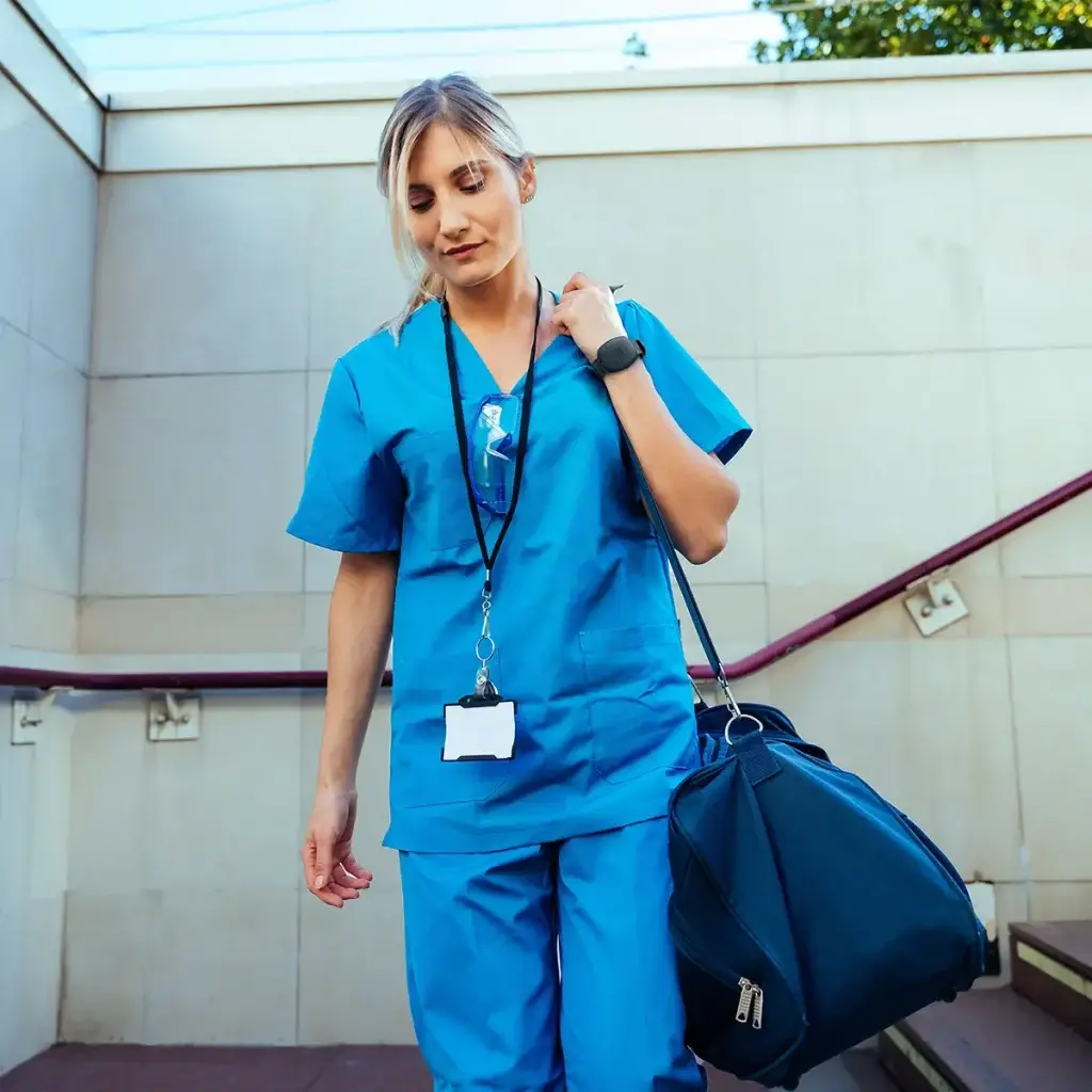 A travel nurse wearing a Silent Beacon device, which shows as activated, to enhance their safety and peace of mind.