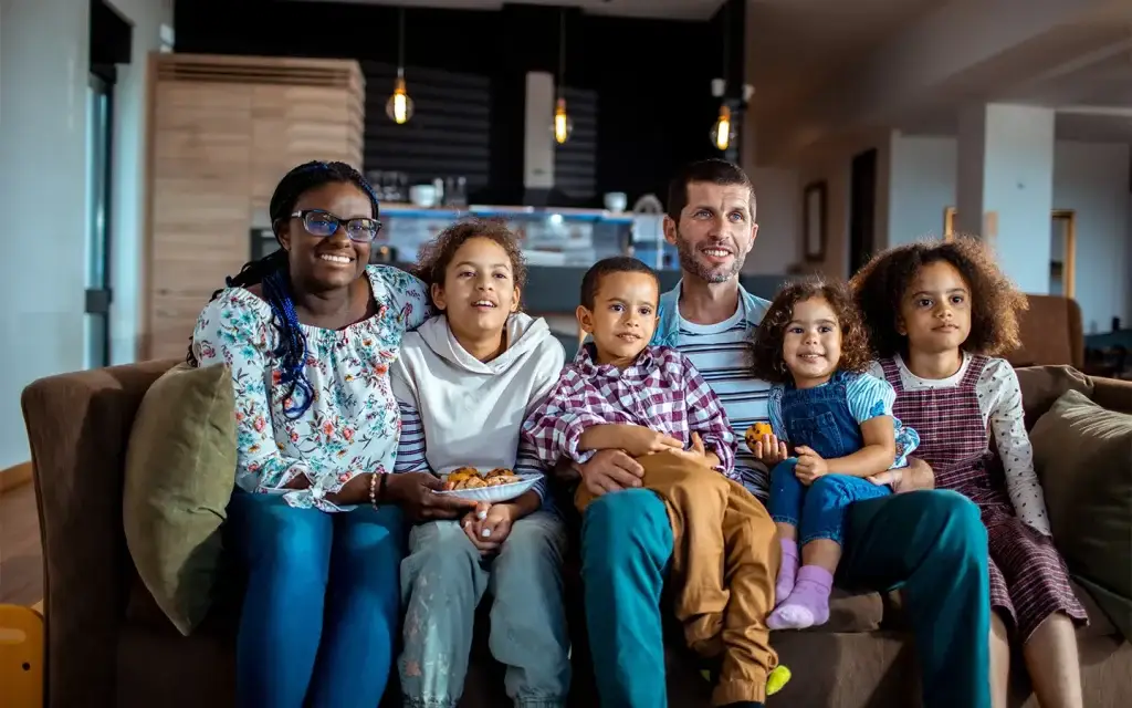 Large family sitting on couch.