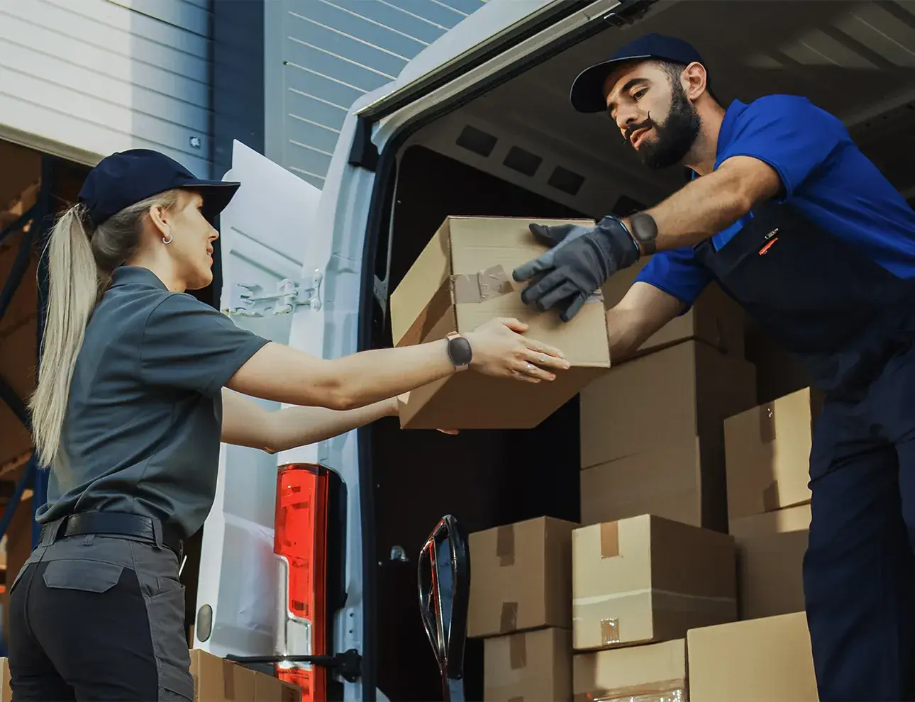 Delivery workers unloading the back of their truck while wearing Silent Beacon