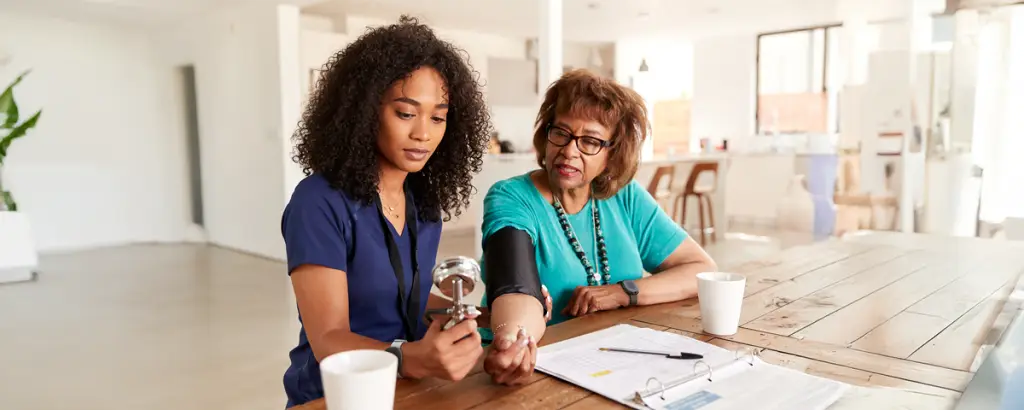 Homecare nurse visiting elderly patient while utilizing Silent Beacon